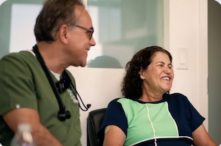 Physician smiling with a patient during a consultation