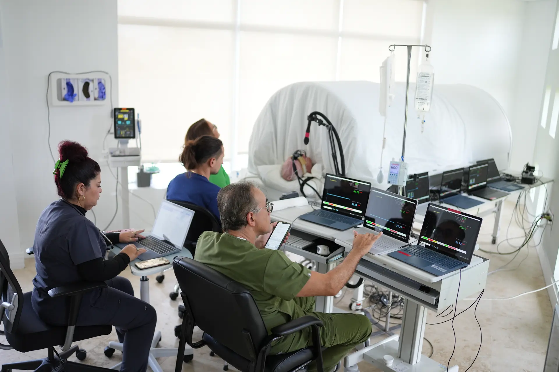 btt clinical team monitoring brain thermodynamic data on multiple screens
