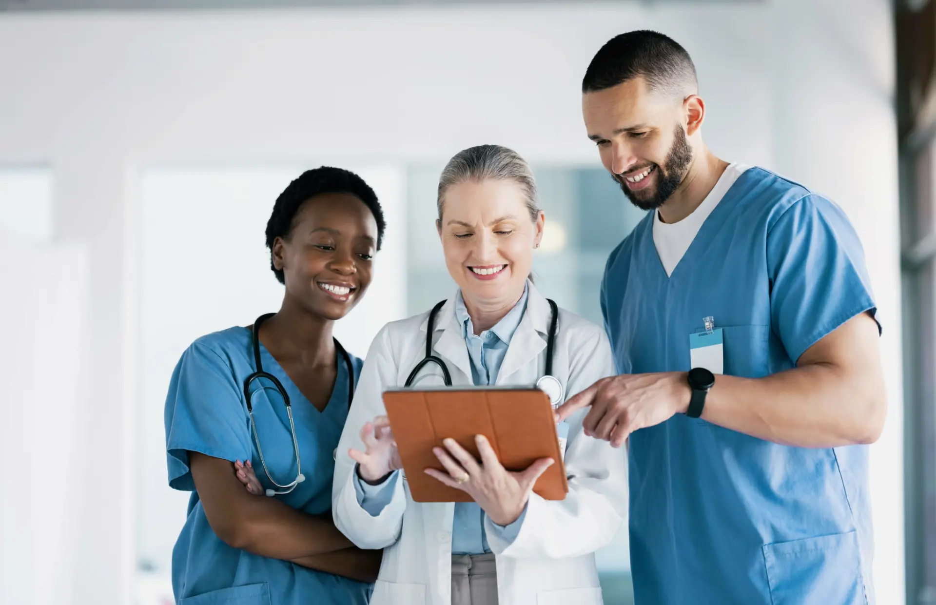 Medical team reviewing patient data on a tablet